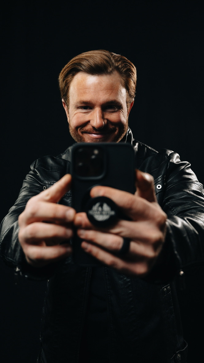 Nick Hiter holding a phone up to take a photo